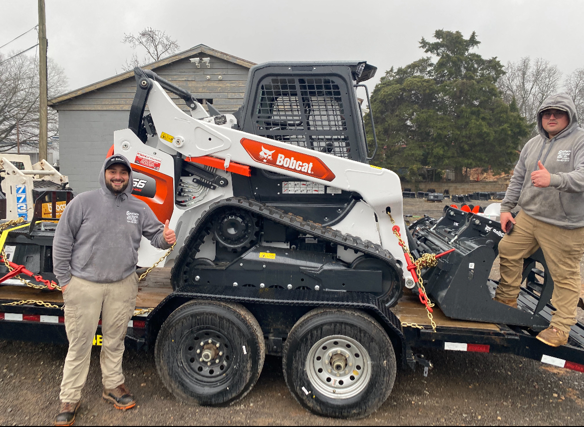 Josh Solano and Kevin with the new Bobcat T66 track loader at Bobcat of Charlotte, taken at the time of purchase