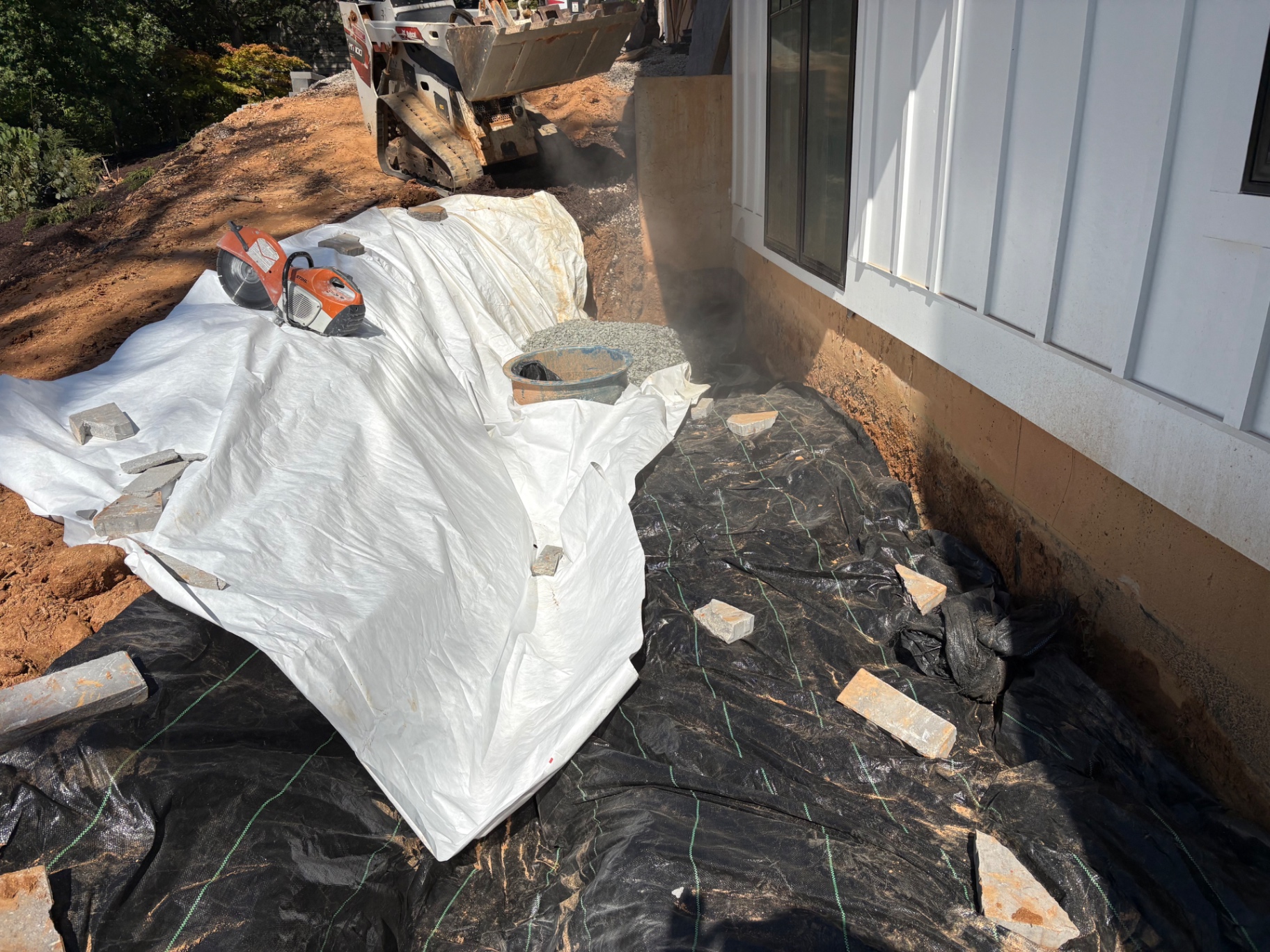 Drainage trench excavated along a home foundation — drainage work by Southern Style Turf & Design in the Lake Norman area