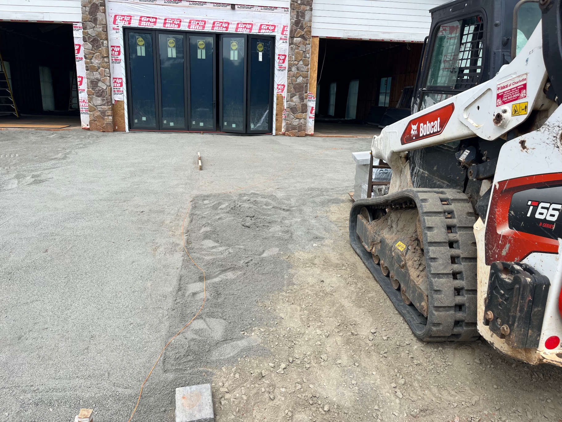 Gravel base laid with a Bobcat on a new-construction lot in Huntersville, NC.